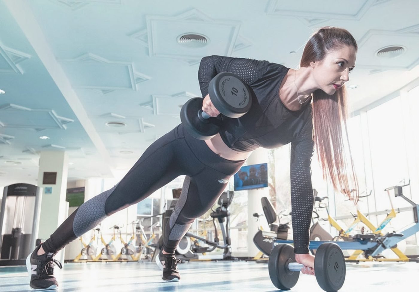 Woman doing a dumbbell workout at the gym